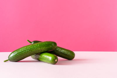 Close-up of green pepper against colored background