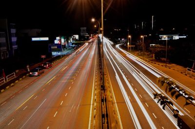 Light trails on road in city at night