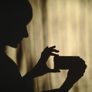 Close-up of hand holding sunglasses