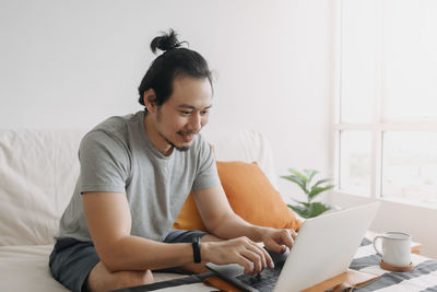 Young woman using laptop at home