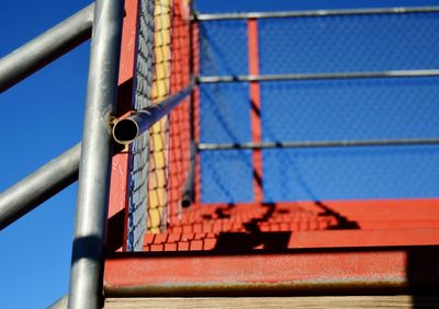 Metal fence against blue sky