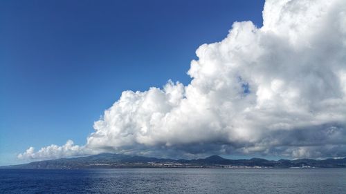 Panoramic view of sea against blue sky