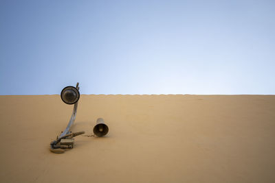 Low angle view of lighting equipment on sand