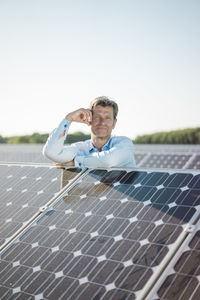 Mature man standing in solar plant