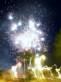 Low angle view of firework display at night