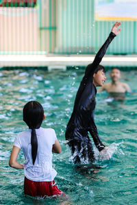 Rear view of women in swimming pool