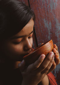 Close-up of young woman drinking water 