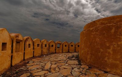 View of old ruin building against cloudy sky