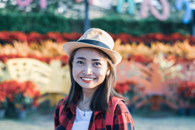 Portrait of smiling young woman wearing hat