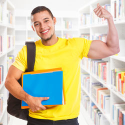 Portrait of smiling young man holding book