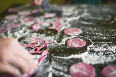 Cropped image of hand making cookies in kitchen