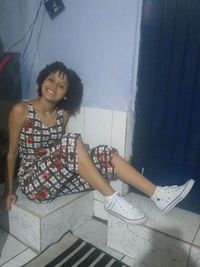 Portrait of a smiling young woman sitting outdoors