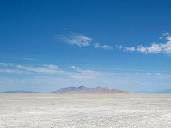 Scenic view of mountains against blue sky