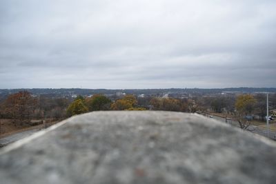 Close-up of wet road against sky