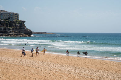 People on beach against sky