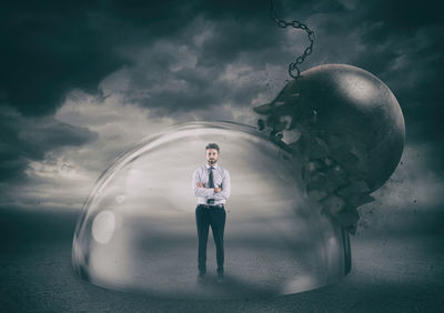 Digital composite image of man standing at bubbles against sky