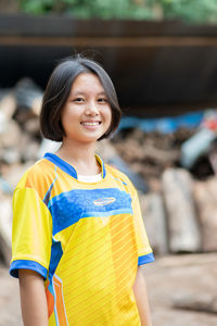 Portrait of smiling girl standing outdoors