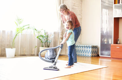 Mother and daughter standing on floor