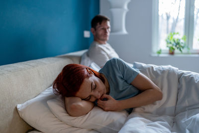 Young woman sleeping on bed at home