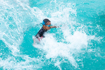 Man surfing in swimming pool