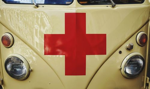 Close-up of vintage car with red cross