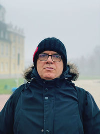 Portrait of man standing in snow