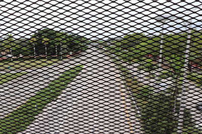 Chainlink fence against cloudy sky