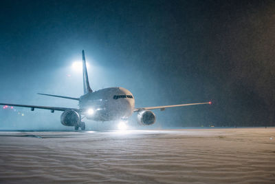 Low angle view of airplane flying against clear sky