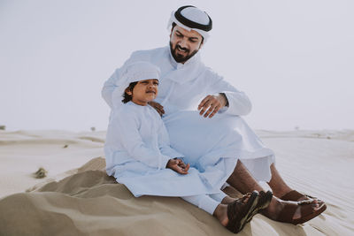 Full length of a man sitting on beach