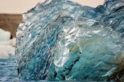 Close-up of frozen sea against sky