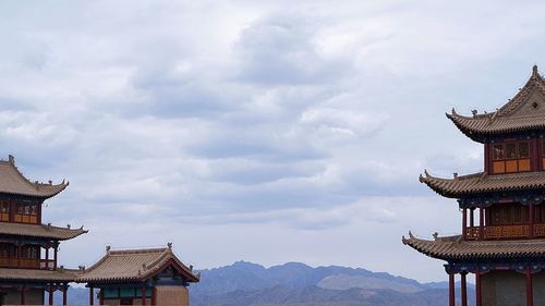 Low angle view of temple against cloudy sky