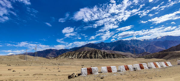 Scenic view of mountains against blue sky