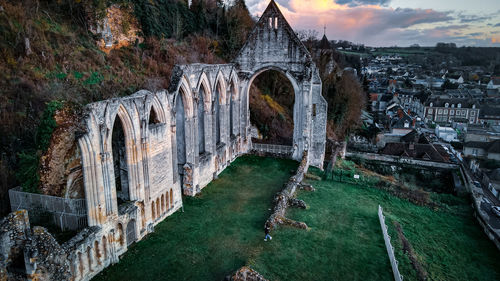 High angle view of old bridge amidst buildings against sky