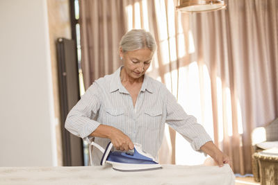 Senior woman ironing