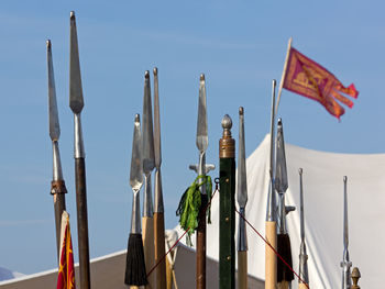 Low angle view of flags against clear blue sky