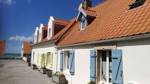 Roof of houses against blue sky