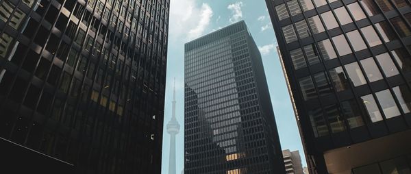 Low angle view of modern buildings in city against sky