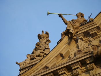 Low angle view of ornate building exterior with angels