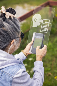 Woman watching fake news on cell phone