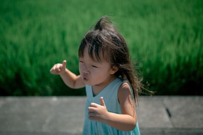 Innocent girl standing by field