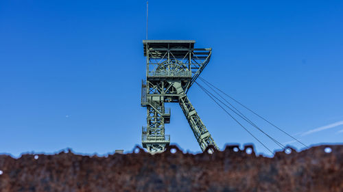 Low angle view of built structure against clear blue sky