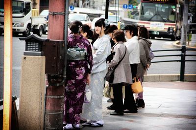 Woman standing on city street