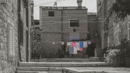 Clothes drying against buildings in city