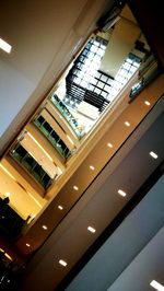 Low angle view of illuminated skylight in building