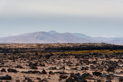 Scenic view of arid landscape against sky