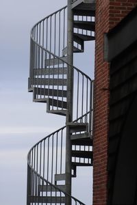 Low angle view of spiral staircase of building against sky