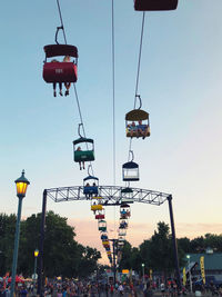 Low angle view of overhead cable cars against sky