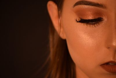 Cropped image of woman against black background