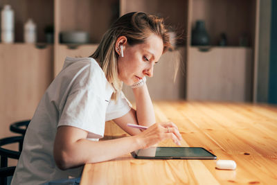 Girl sitting on table at home