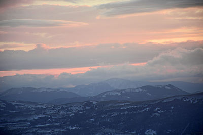 Scenic view of snowcapped mountains against sky during sunset